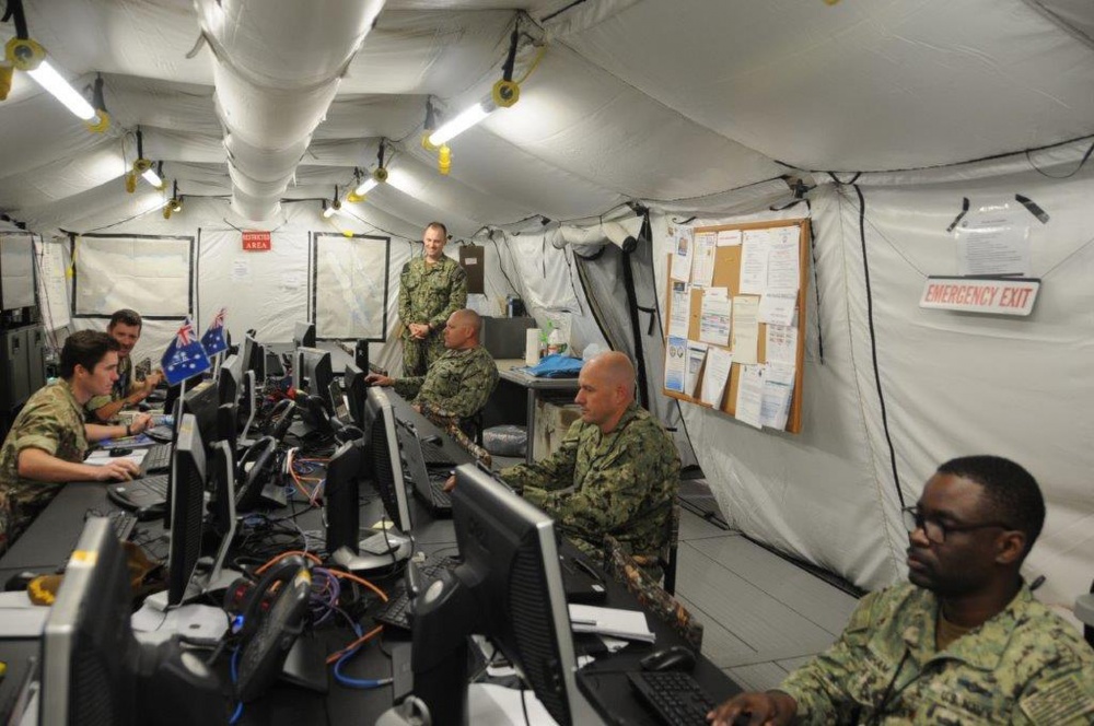 Photo By NAVCENT Public Affairs | 200330-N-NO146-1002 MANAMA Bahrain (March 30, 2020) Service members assigned to the International Maritime Security Construct (IMSC) practice social distancing in the workspace. The IMSC ensures freedom of navigation and free flow of commerce in international waters throughout the Arabian Gulf, Strait of Hormuz, the Bab el-Mandeb Strait, and the Gulf of Oman.